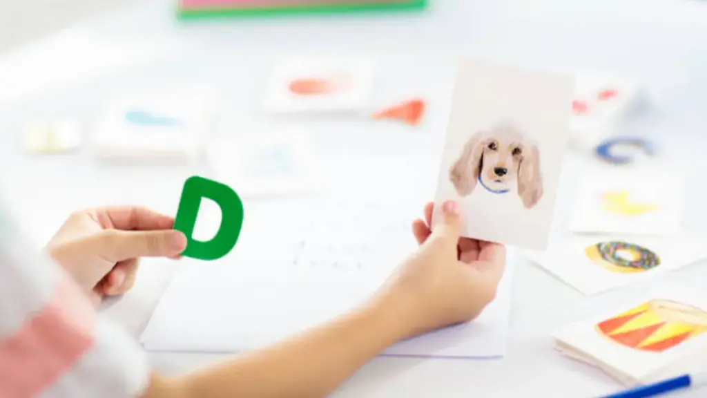 a kid reading phonics with flashcards