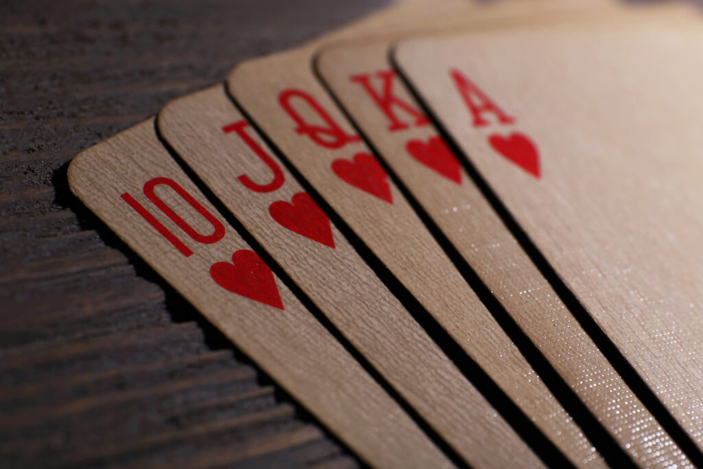 Playing cards on wooden table, closeup